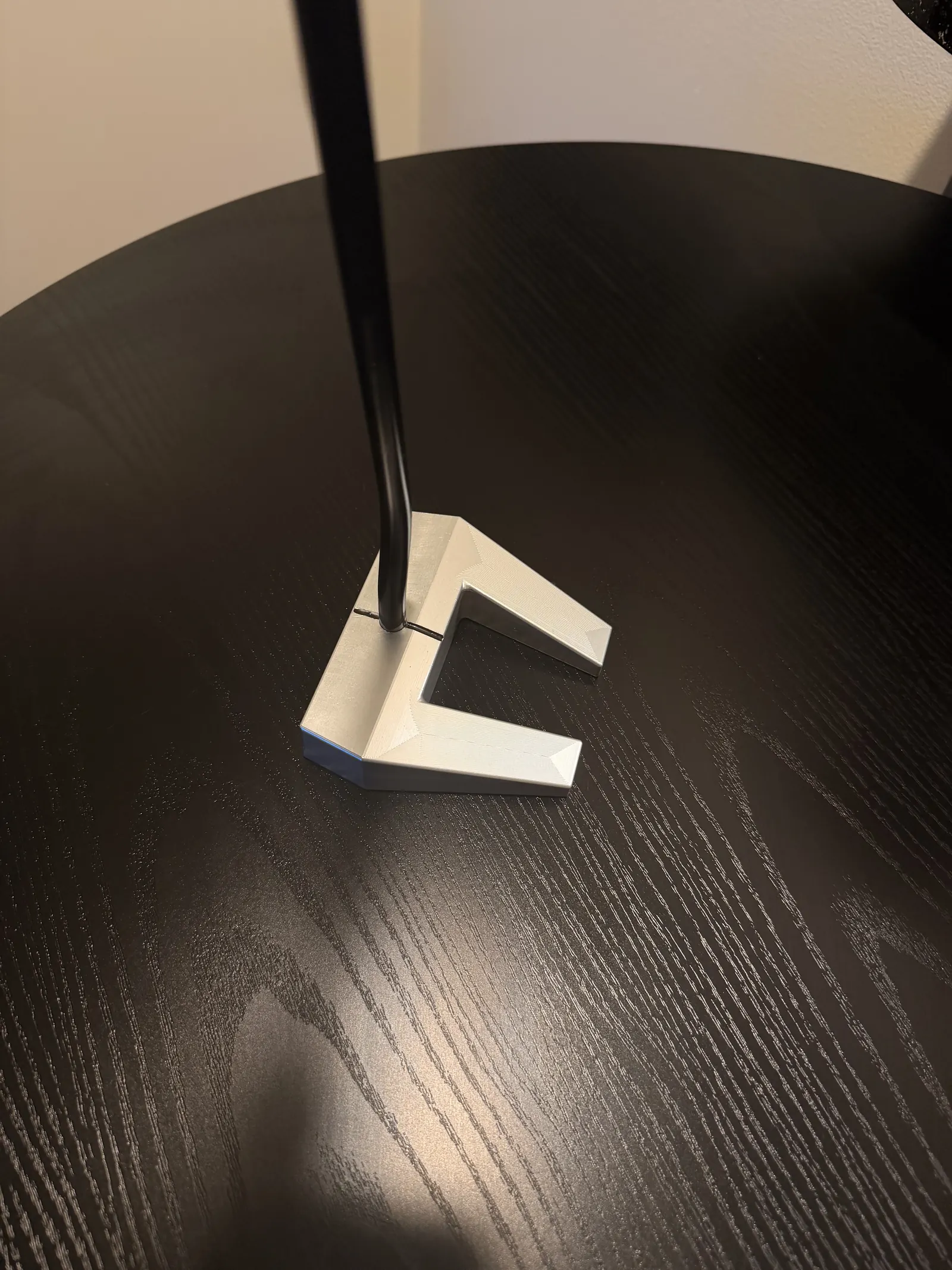 Top-down geometry view of the completed putter head showing cavity, alignment line, and center-shaft entry