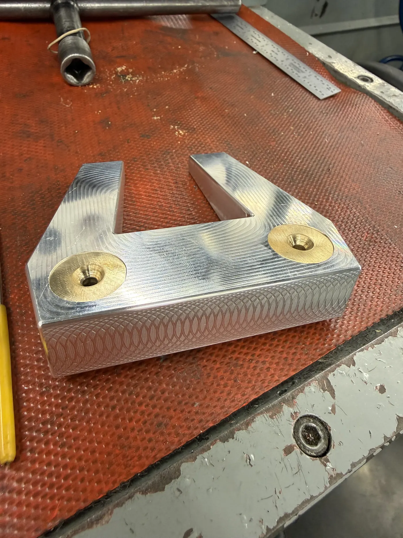 Completed head assembly with both brass weights installed, angled view