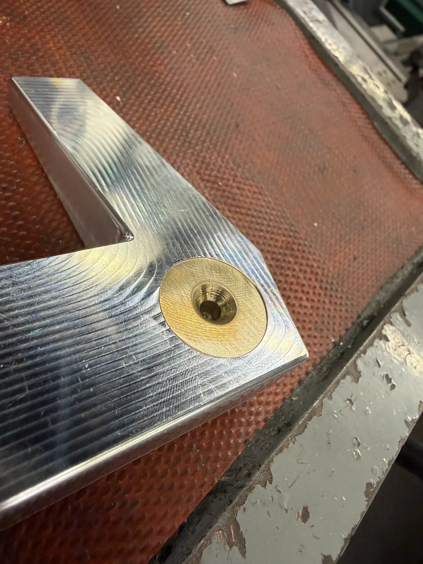 Angled close-up of the machined head and brass weight
