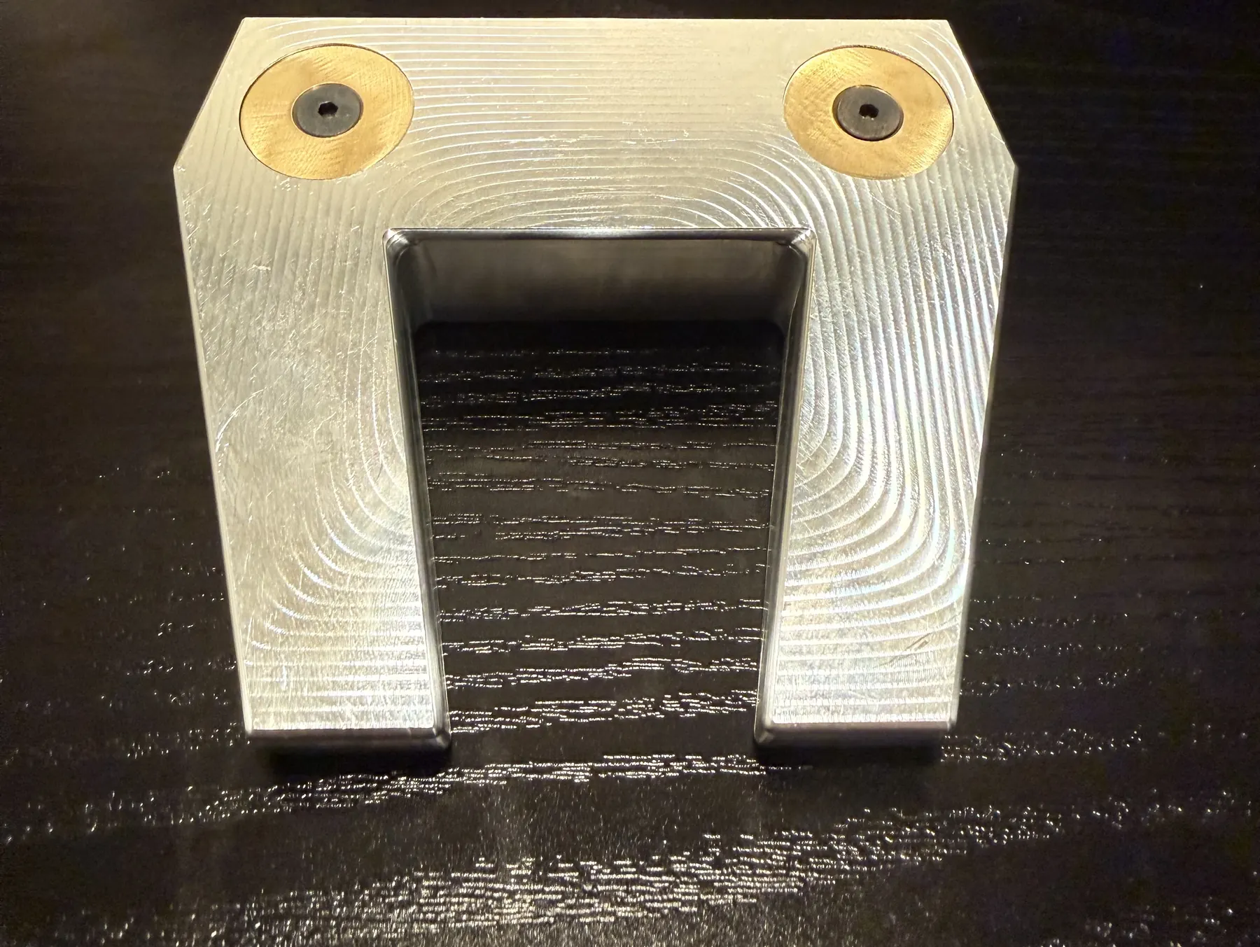 CNC-machined aluminum putter head with brass weights installed, completed head assembly