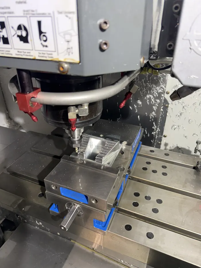 CNC mill roughing the aluminum putter head block, flood coolant active